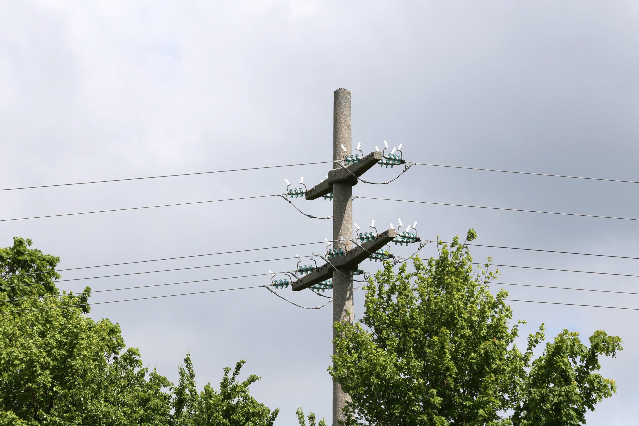 low angle shot of high voltage electric tower under a cloudy sky