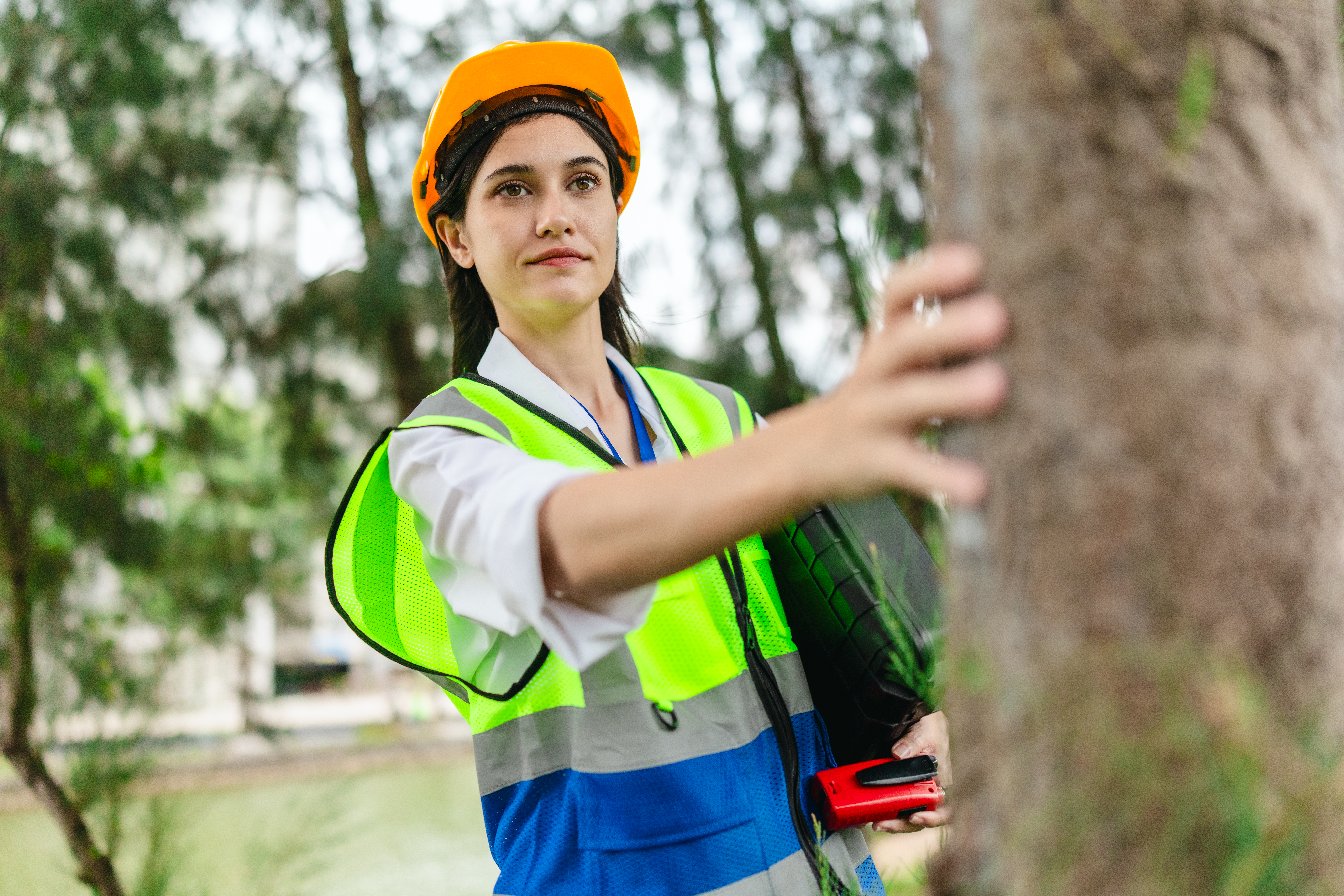 female surveyor measuring trees for carbon credit assessment
