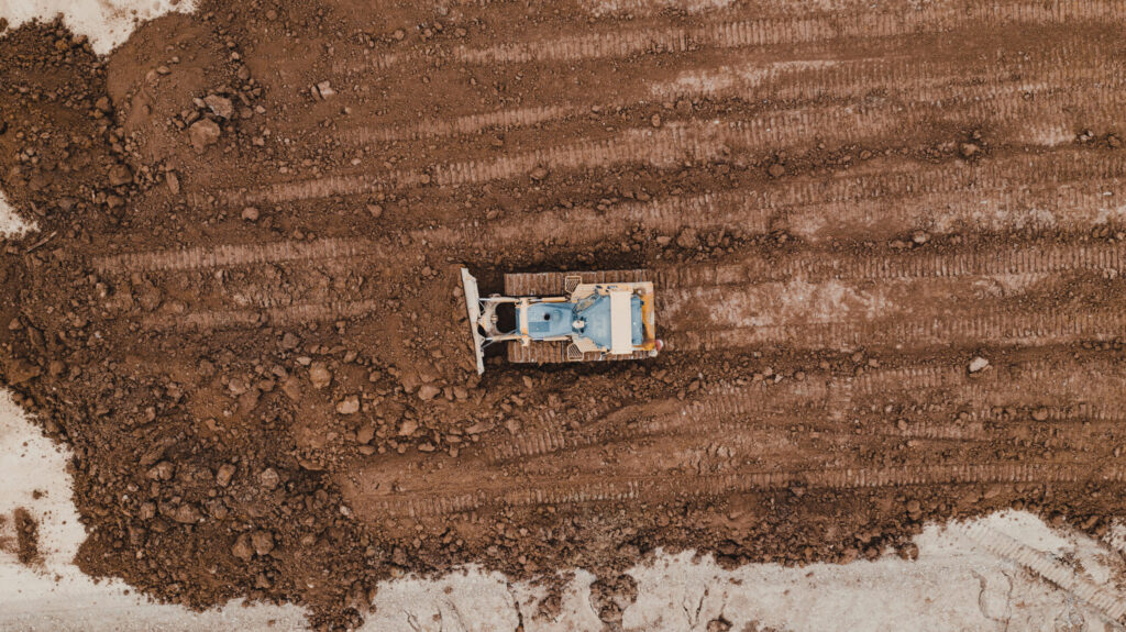 aerial view of ground excavation machine on construction site.